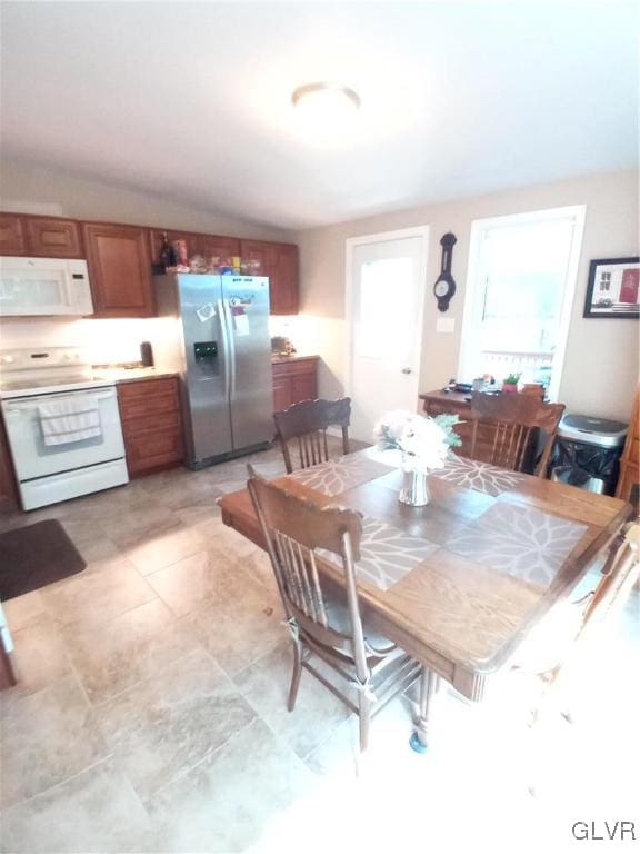 dining room with lofted ceiling