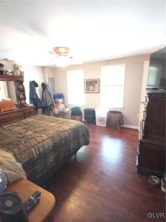 bedroom featuring dark wood-type flooring and a wall mounted air conditioner