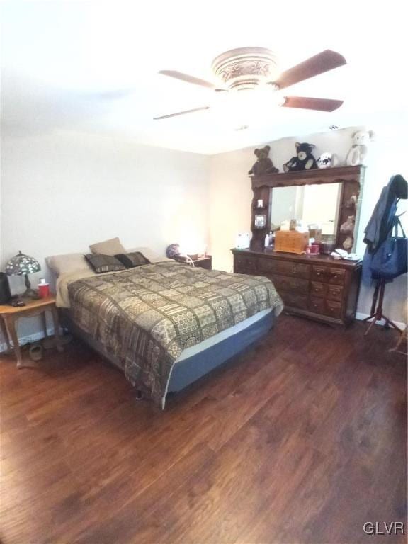 bedroom featuring ceiling fan and dark hardwood / wood-style floors