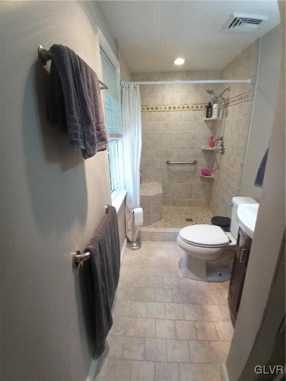 bathroom featuring walk in shower, vanity, and toilet