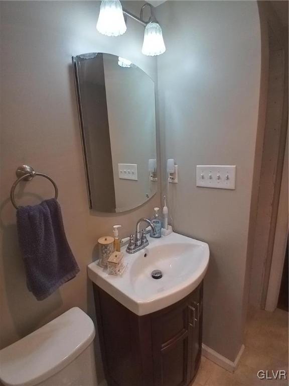 bathroom with vanity, toilet, and tile patterned floors