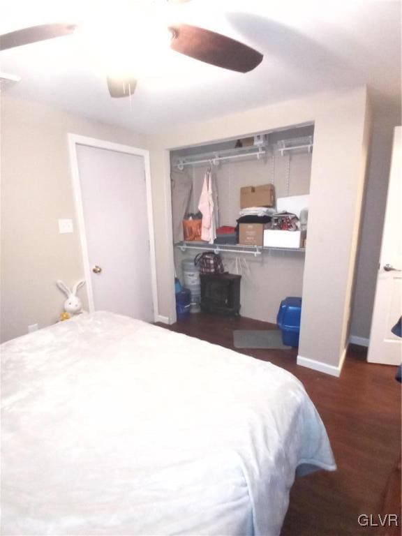 bedroom with ceiling fan and dark wood-type flooring