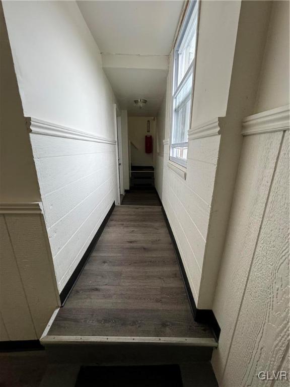 hallway with dark wood-type flooring