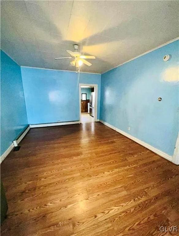 bonus room featuring ceiling fan, hardwood / wood-style flooring, and baseboard heating