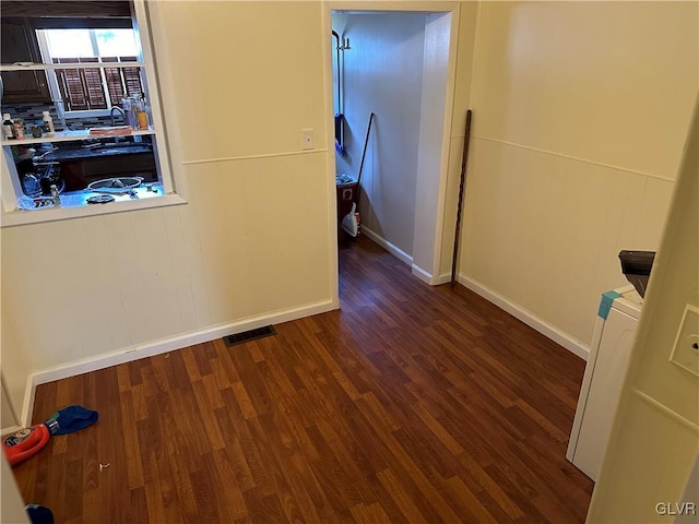 hallway with dark hardwood / wood-style floors