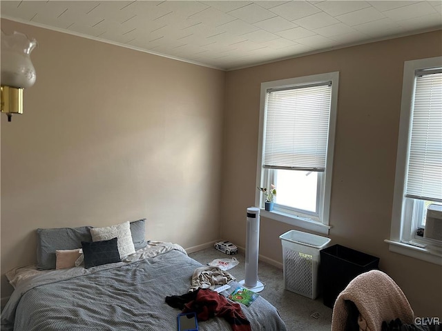 carpeted bedroom with ornamental molding