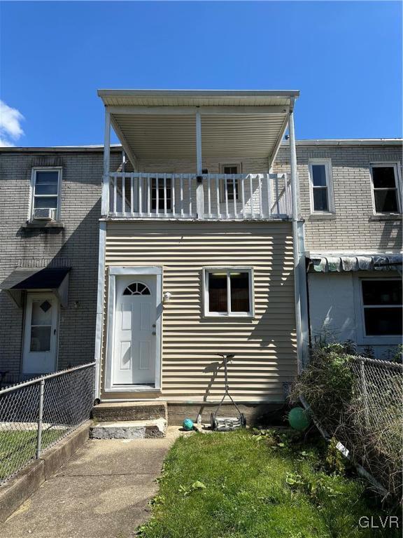 view of front of home with a balcony