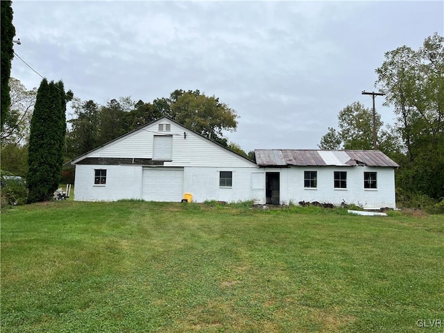 rear view of property with a yard