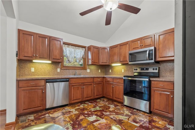 kitchen featuring ceiling fan, lofted ceiling, sink, tasteful backsplash, and appliances with stainless steel finishes