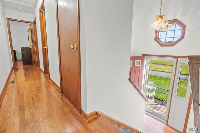 foyer featuring light hardwood / wood-style flooring and a chandelier