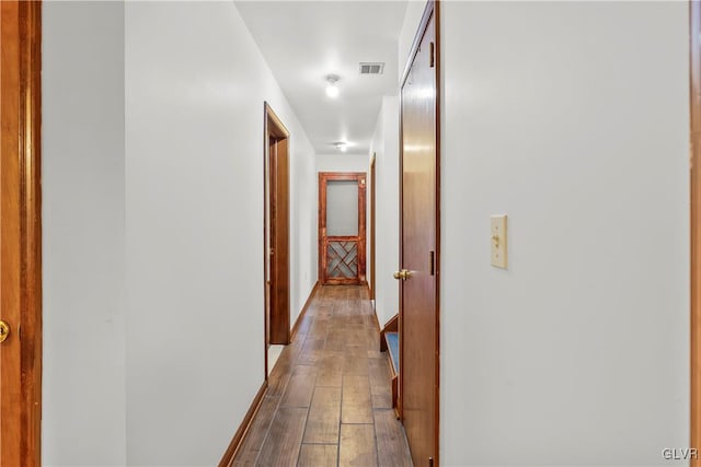 hallway with hardwood / wood-style flooring