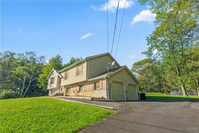 view of front of house featuring a garage and a front lawn