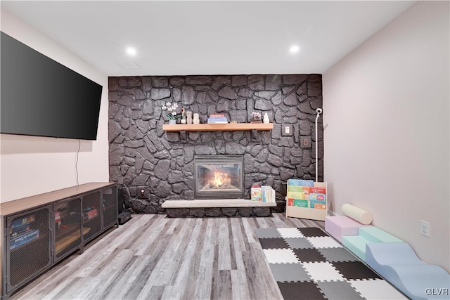 unfurnished living room with a fireplace and light wood-type flooring