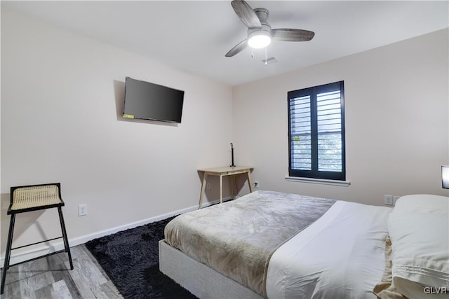 bedroom with light hardwood / wood-style flooring and ceiling fan