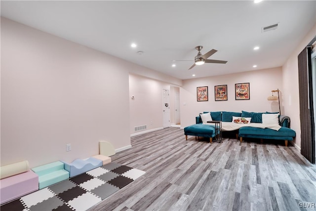 sitting room with light hardwood / wood-style flooring and ceiling fan