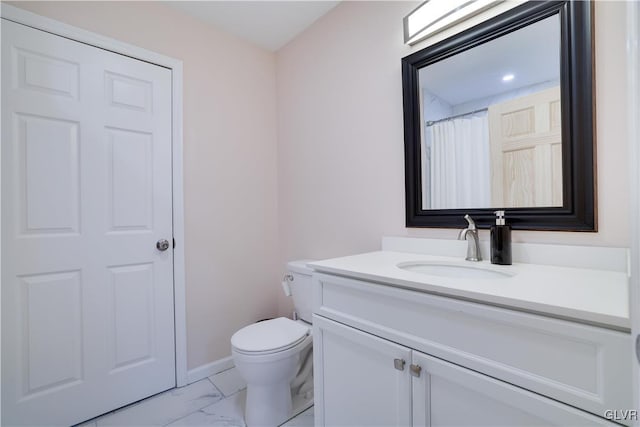 bathroom featuring vanity and toilet