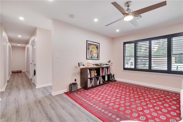 living area with light hardwood / wood-style flooring and ceiling fan