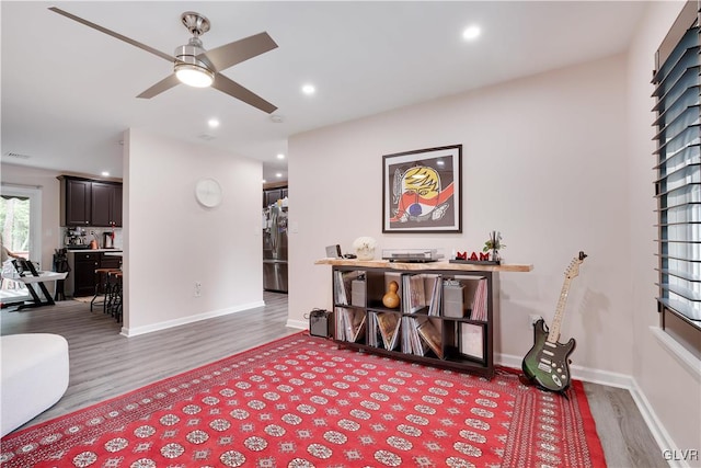 sitting room featuring hardwood / wood-style floors and ceiling fan