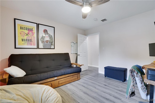 living room with light hardwood / wood-style flooring and ceiling fan