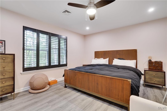 bedroom with ceiling fan and light hardwood / wood-style floors