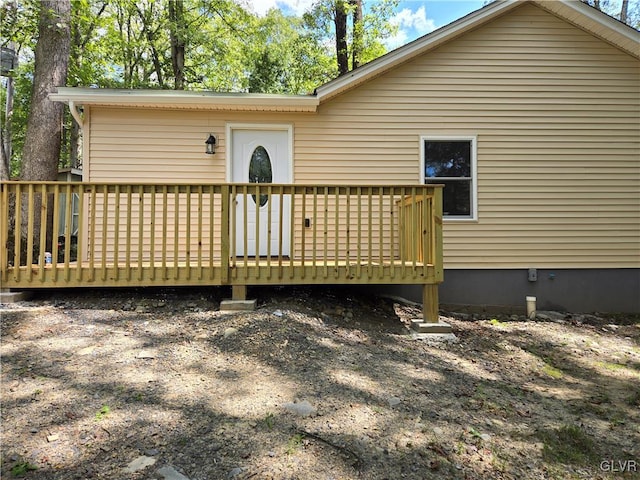 back of house with a deck