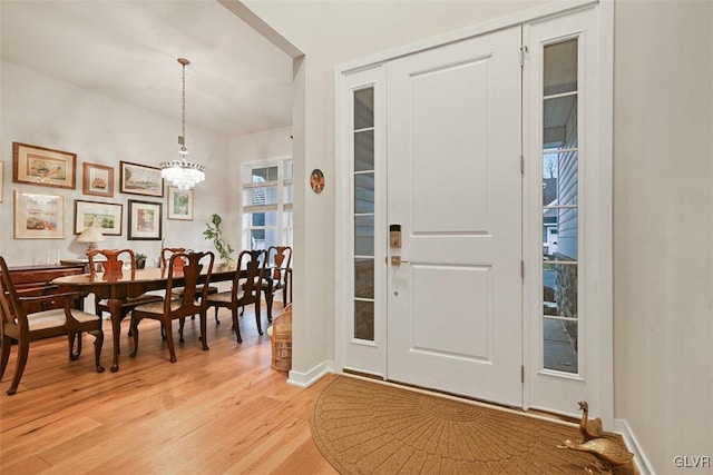 entryway featuring light hardwood / wood-style flooring and a notable chandelier