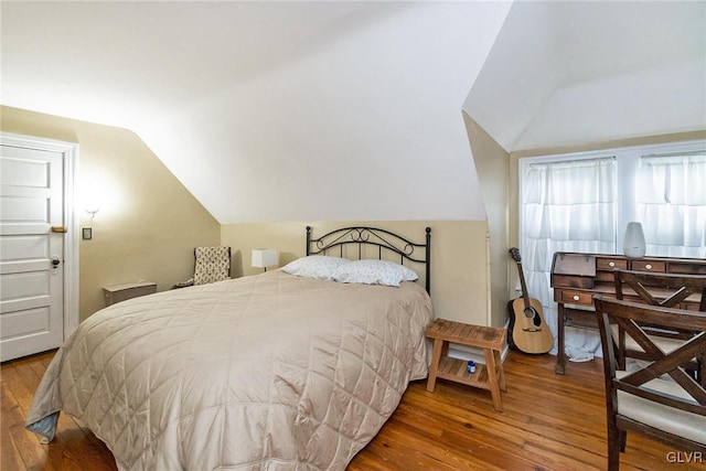 bedroom featuring vaulted ceiling and hardwood / wood-style floors