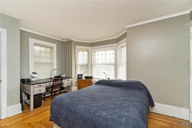 bedroom with crown molding and light parquet flooring