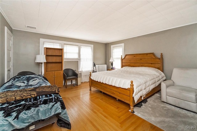 bedroom featuring crown molding and radiator heating unit