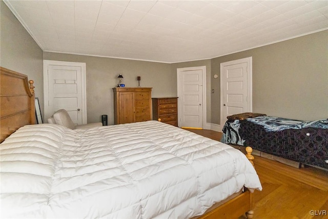 bedroom with hardwood / wood-style floors and crown molding