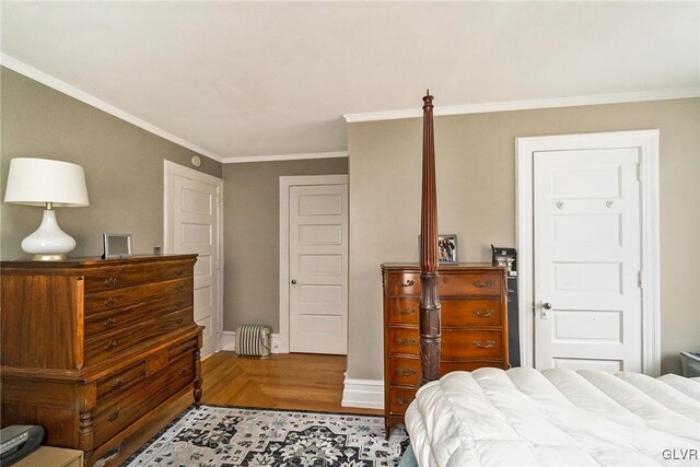 bedroom featuring hardwood / wood-style flooring and crown molding