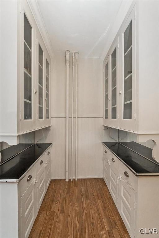 kitchen with dark wood-type flooring and white cabinets