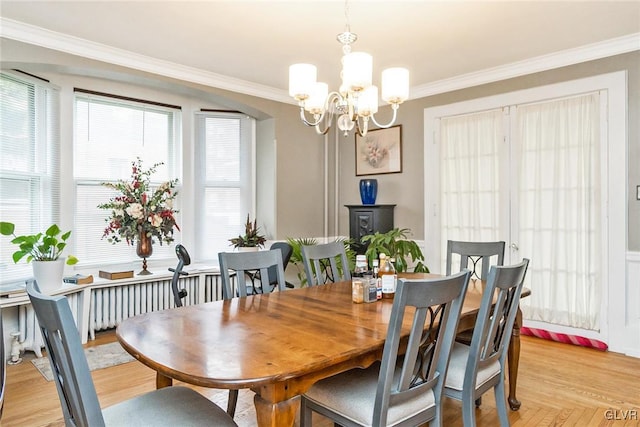 dining room featuring a notable chandelier, a wealth of natural light, and crown molding