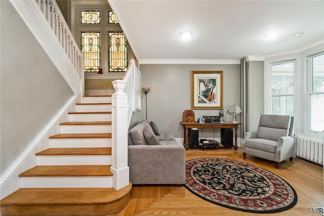 stairs featuring ornamental molding and radiator heating unit