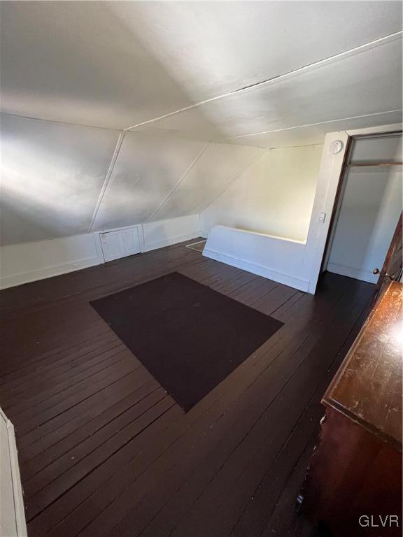 interior space with lofted ceiling and dark hardwood / wood-style floors