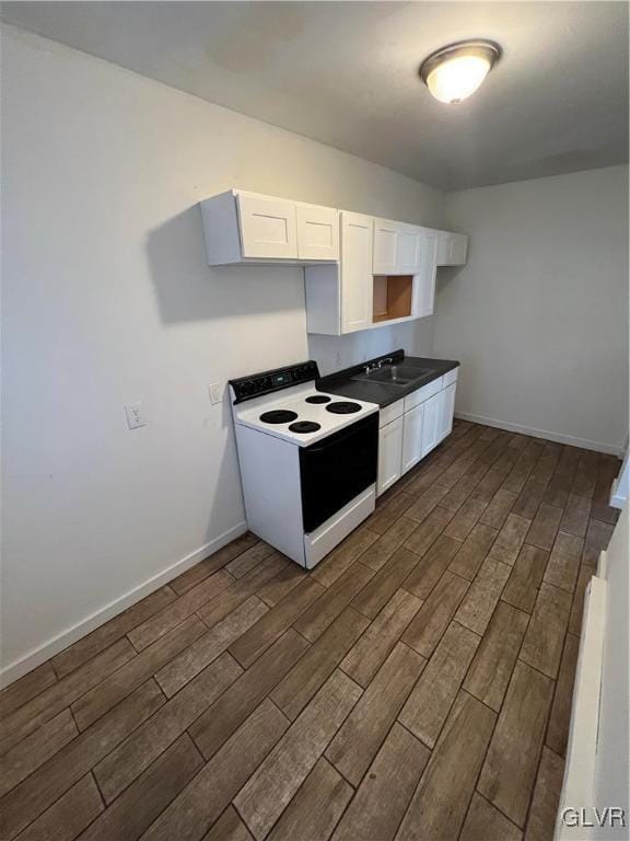 kitchen with sink, dark wood-type flooring, electric range, and white cabinetry