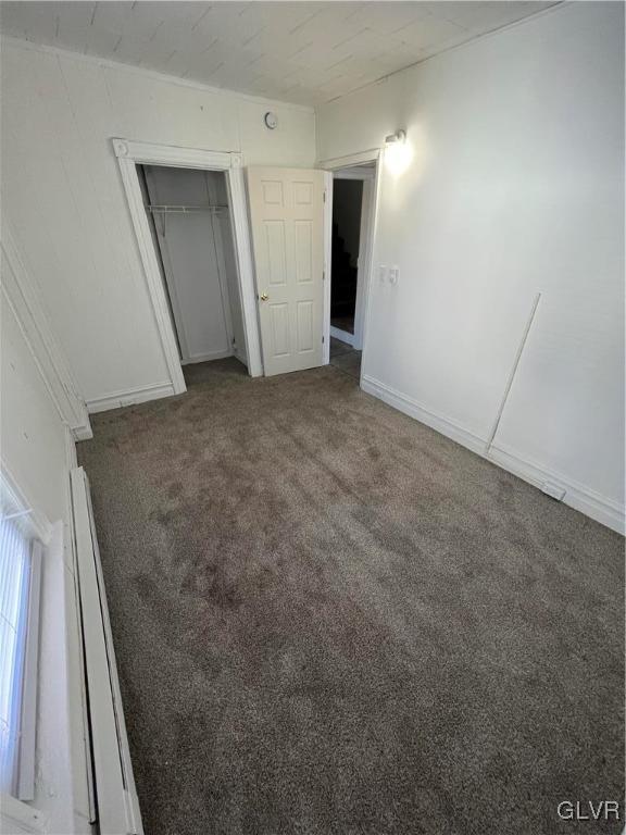 unfurnished bedroom featuring a closet and carpet