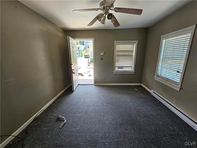 spare room featuring ceiling fan, a baseboard radiator, and dark carpet