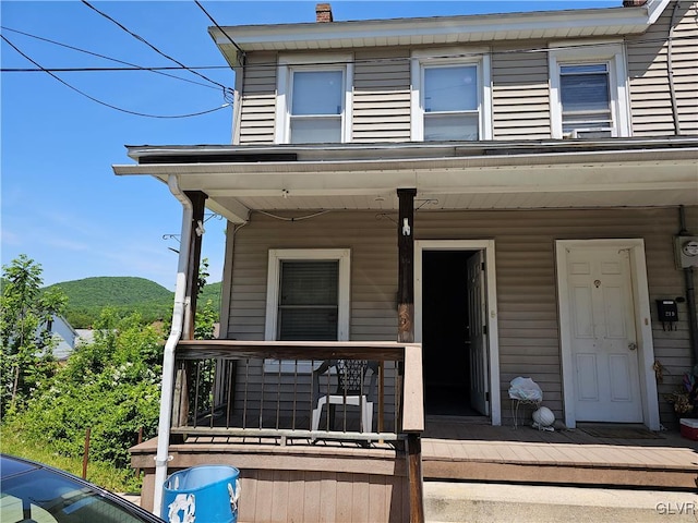 view of front of property featuring a mountain view and covered porch