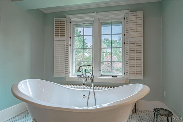 bathroom with ornamental molding, tile patterned flooring, and a bathing tub