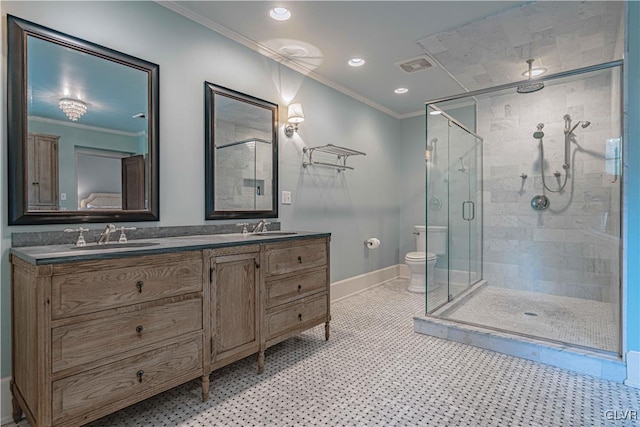 bathroom featuring toilet, ornamental molding, vanity, and a shower with door