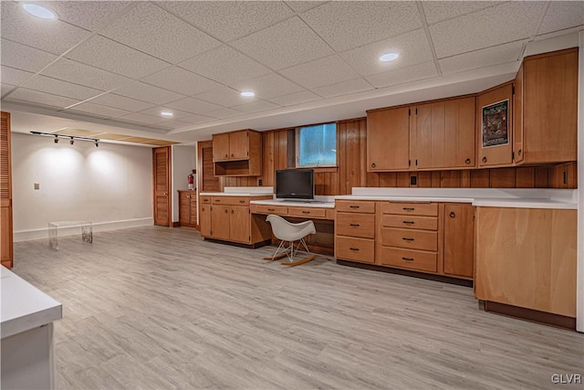 kitchen featuring light hardwood / wood-style floors and a drop ceiling