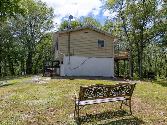 view of property exterior featuring a deck and a lawn