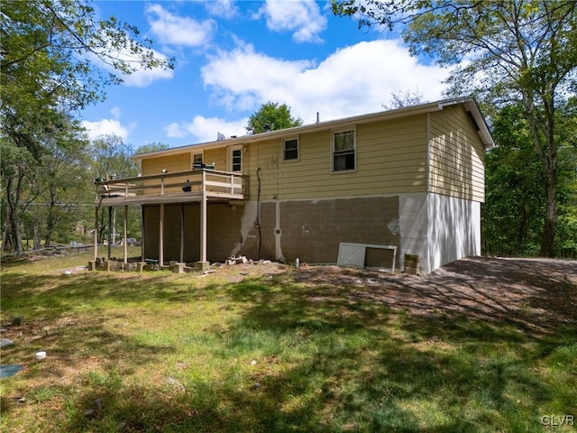 rear view of property featuring a yard