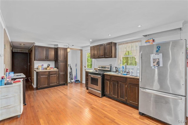 kitchen with crown molding, light hardwood / wood-style floors, dark brown cabinetry, and stainless steel appliances