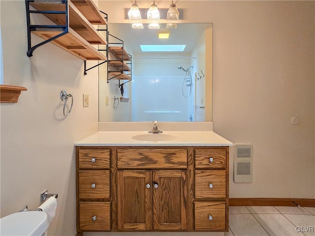 bathroom with walk in shower, tile patterned flooring, vanity, and toilet