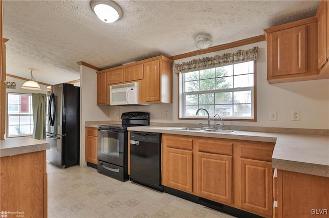 kitchen featuring ornamental molding, black appliances, a textured ceiling, and sink