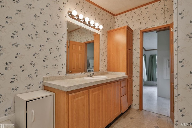 bathroom with crown molding, tile patterned flooring, and vanity