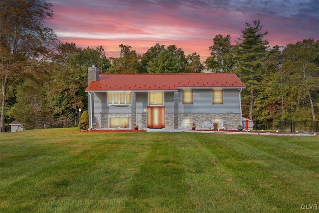 bi-level home featuring a yard