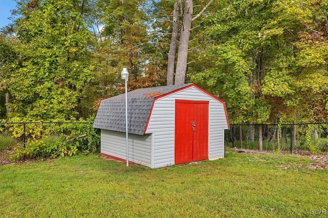 view of outbuilding featuring a lawn